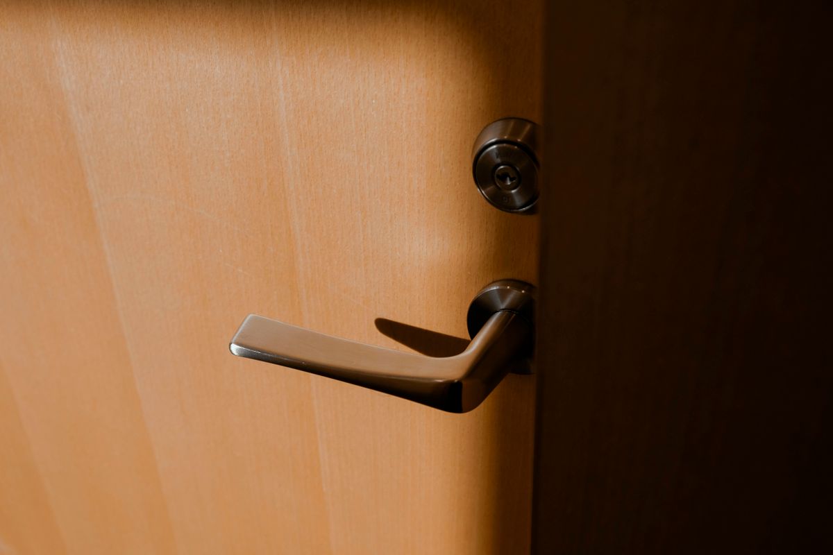 Aluminium bifold door hardware close-up showing handle and locking mechanism