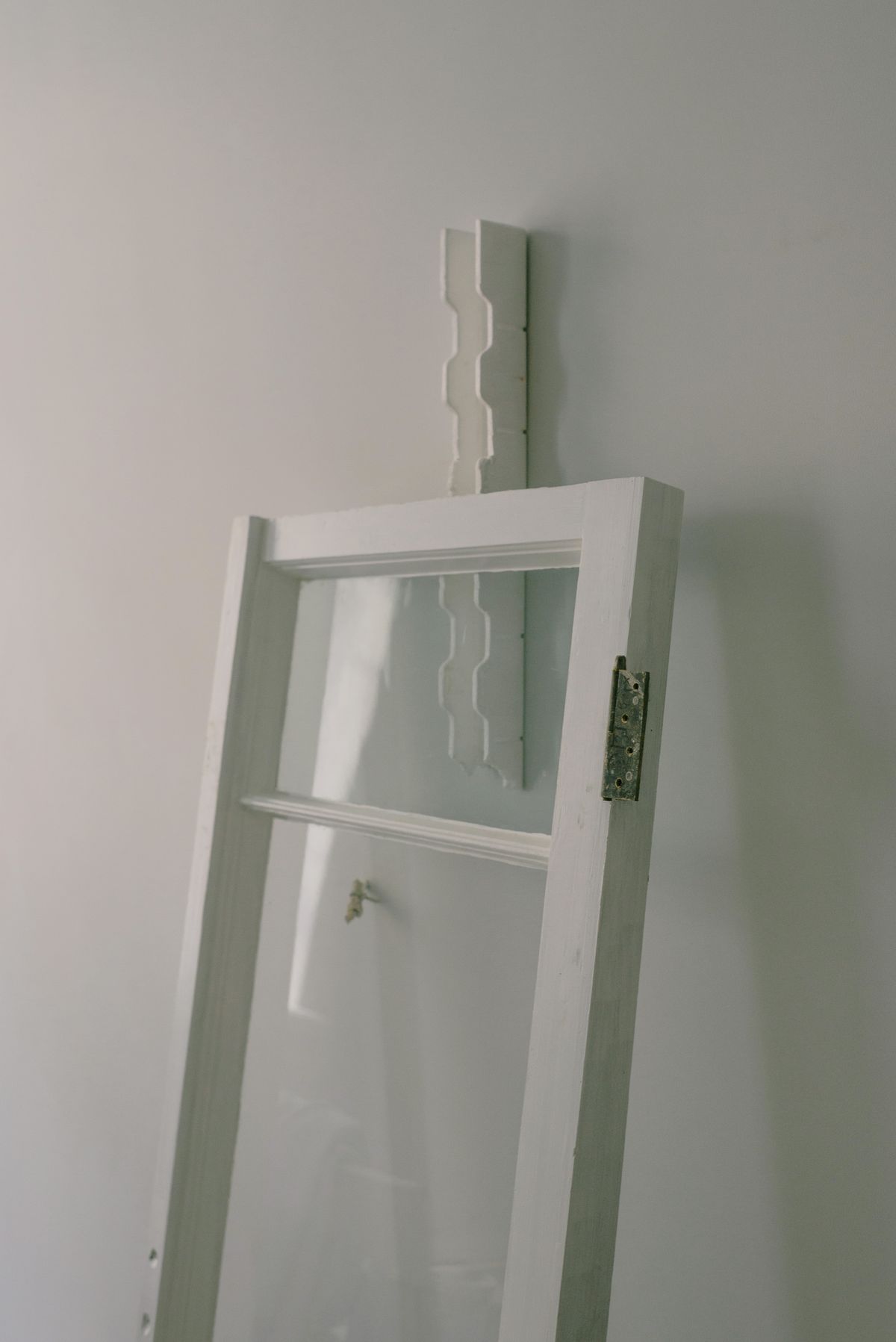 White aluminium casement window frame detail showing sash and outer frame profile