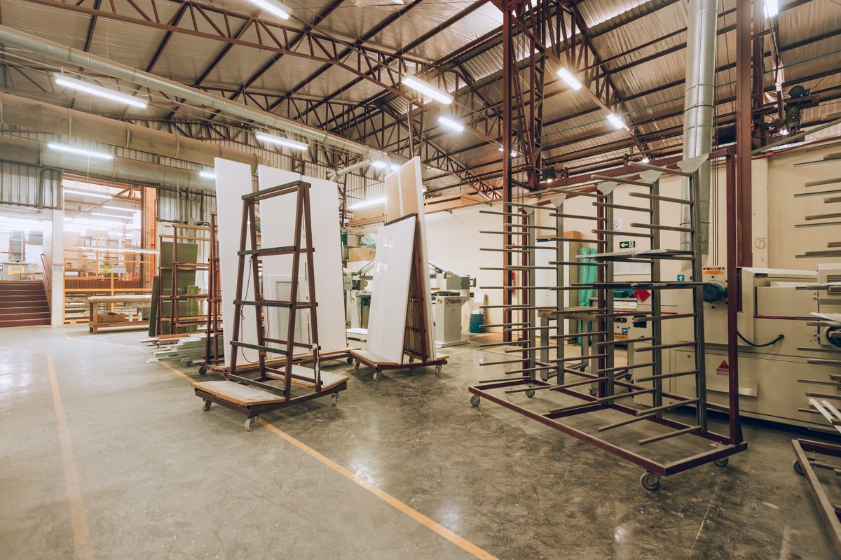 Modern aluminium extrusion factory interior with profile racks and production equipment