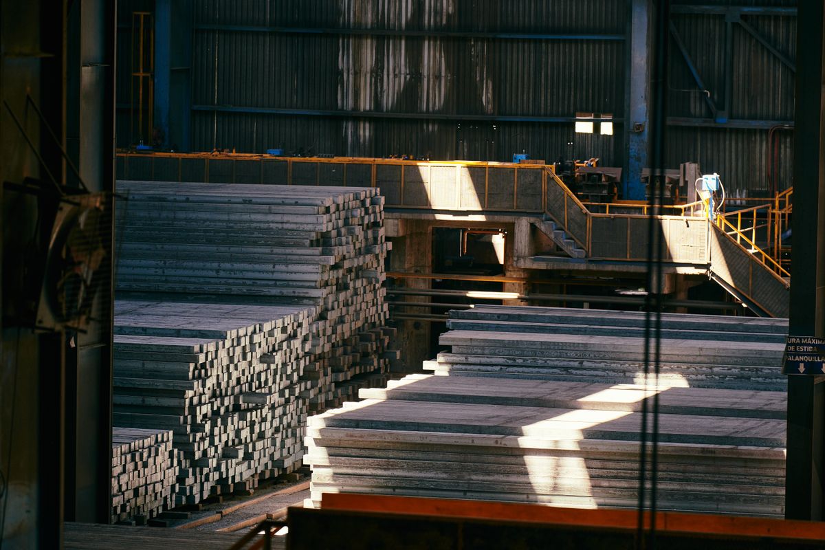 Aluminium factory warehouse with stacked metal sheets for window production