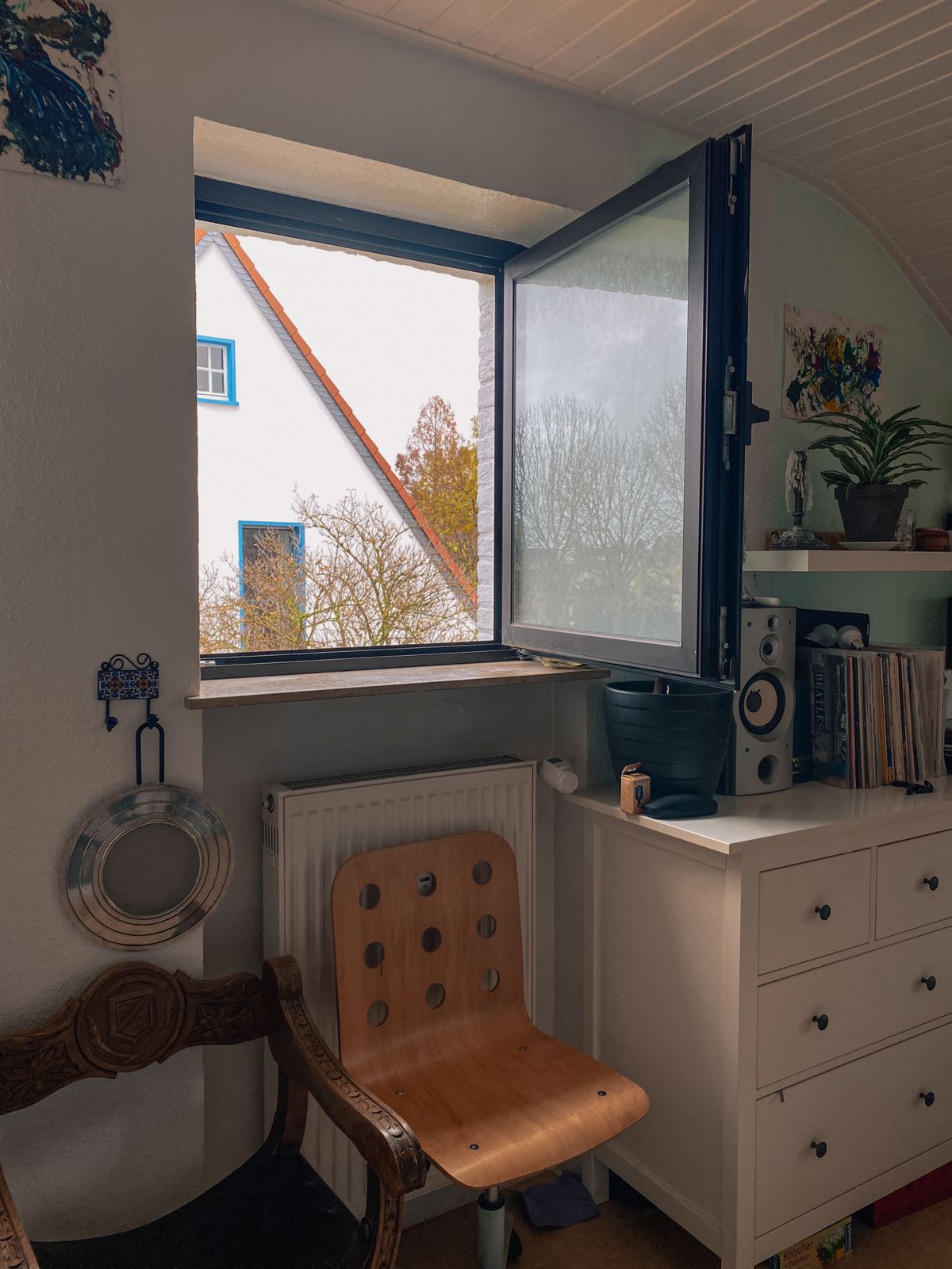 Aluminium tilt and turn window opened in turn mode inside a room