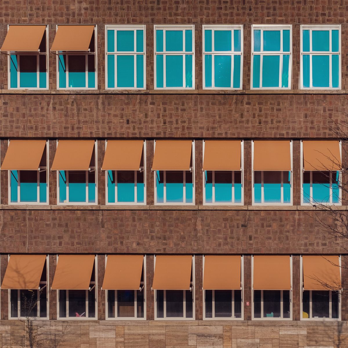 Modern building facade with aluminium awning windows and sun shading