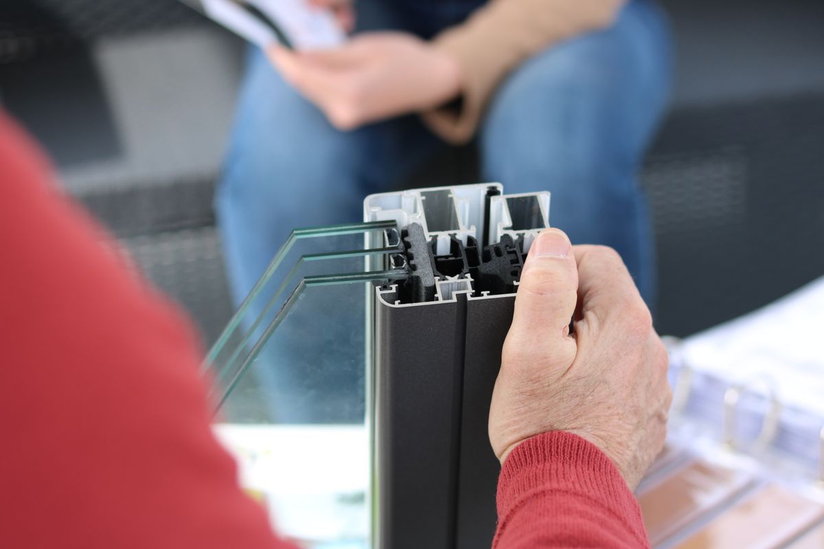 Cut-away aluminium window frame corner sample showing glass panes and EPDM gasket seats