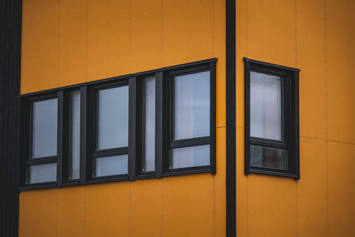 Black aluminium window frames installed on a modern building facade