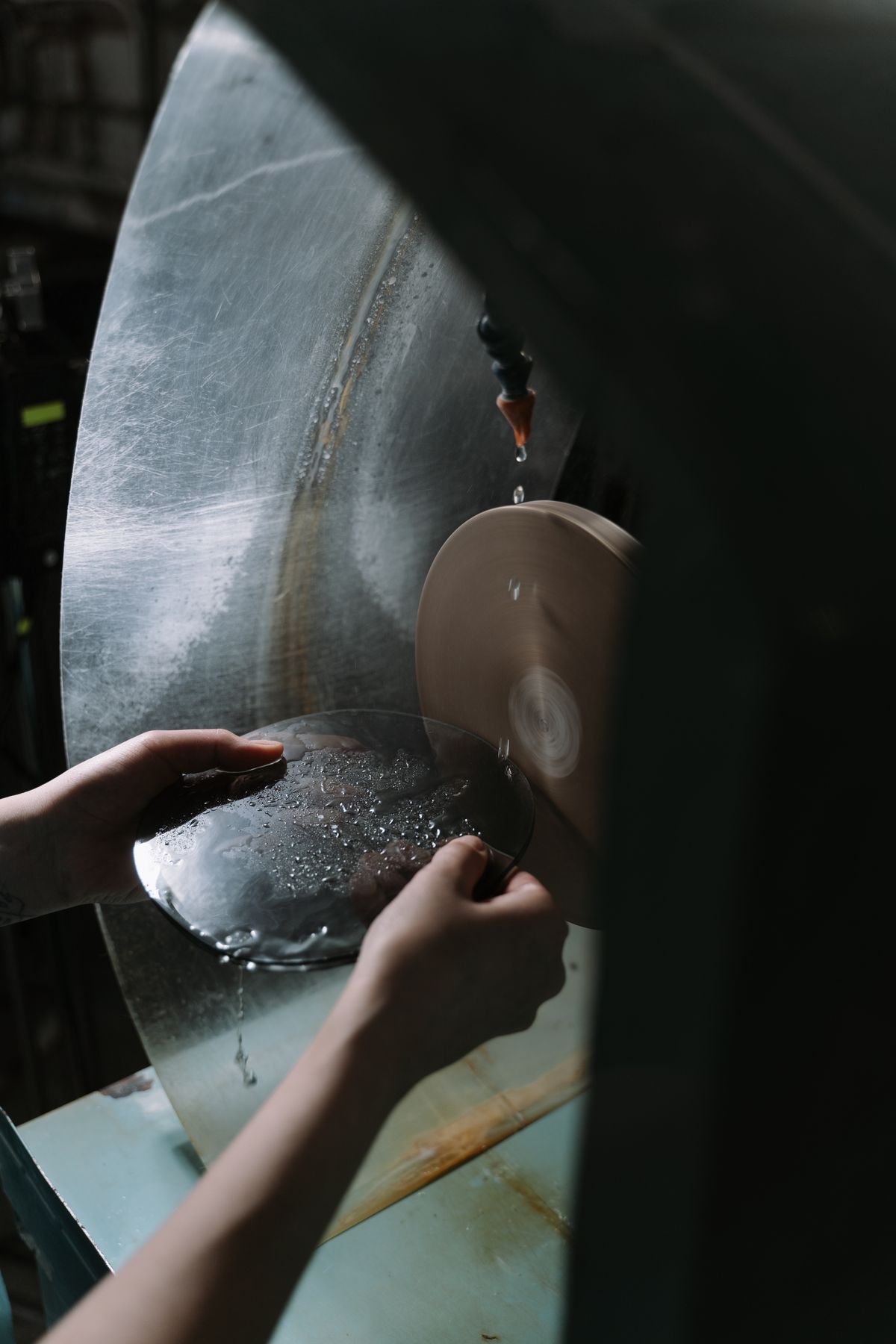 Glass being cut and ground during insulated glass unit fabrication