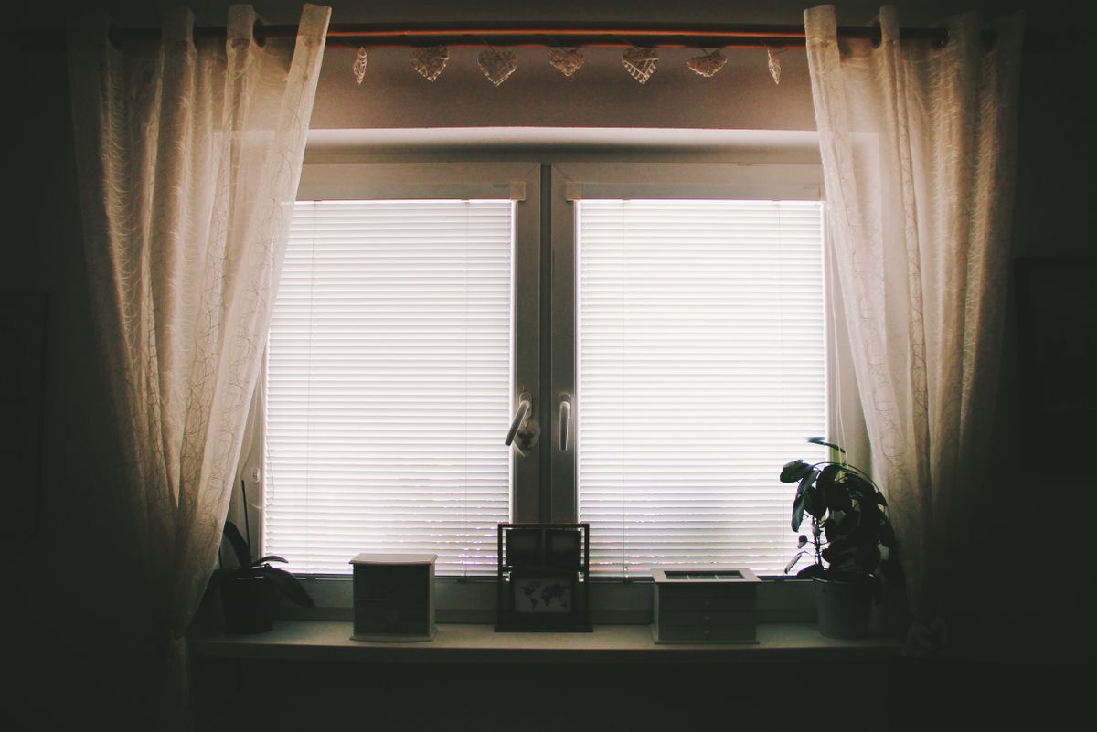 White framed tilt and turn window in a residential interior, typical uPVC style
